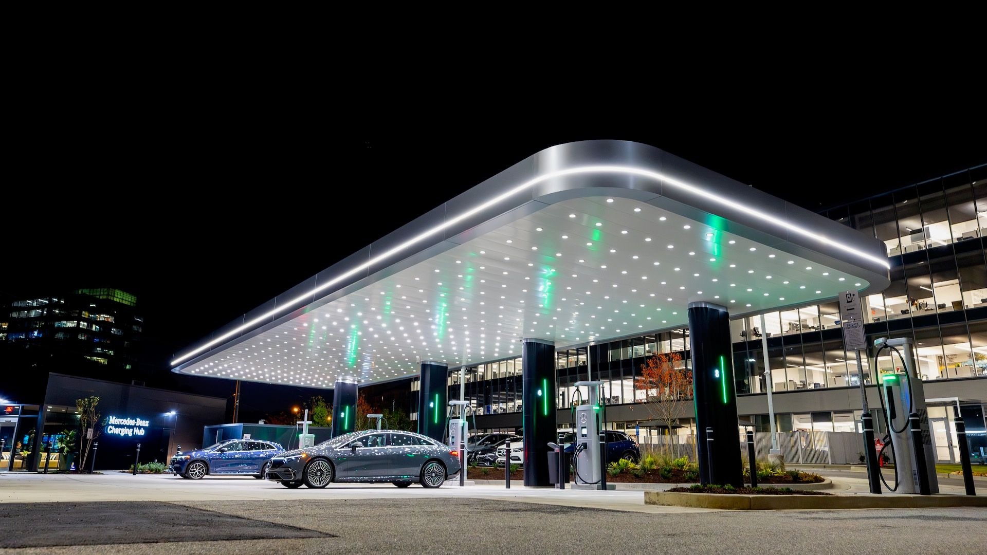 Modern EV fast-charging hub with vehicles charging