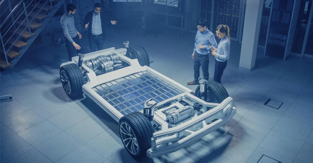 Engineers reviewing an electric vehicle chassis platform